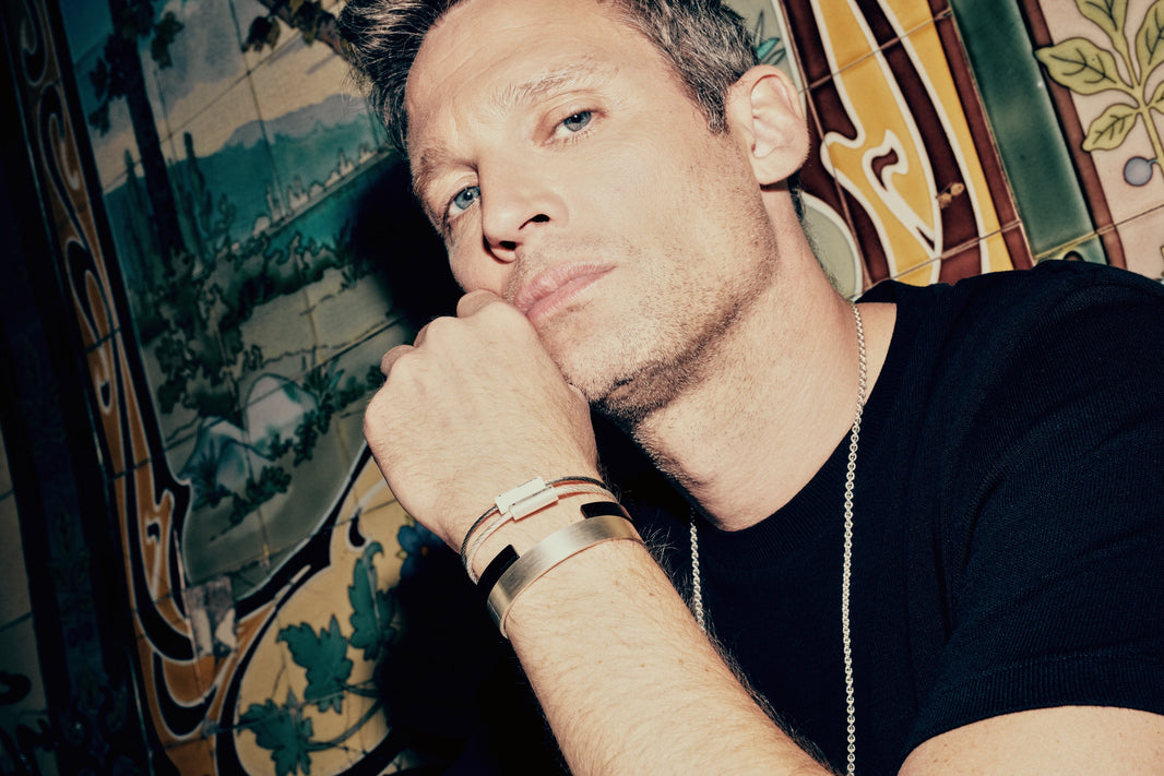 A man wearing Le Gramme bracelets